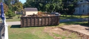a customer submitted photo of a dumpster delivered in the front yard